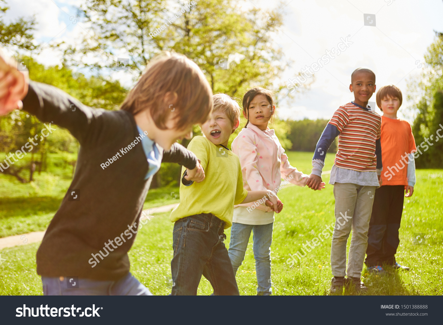 Group of kids holds on to hands in kindergarten or summer camp #1501388888