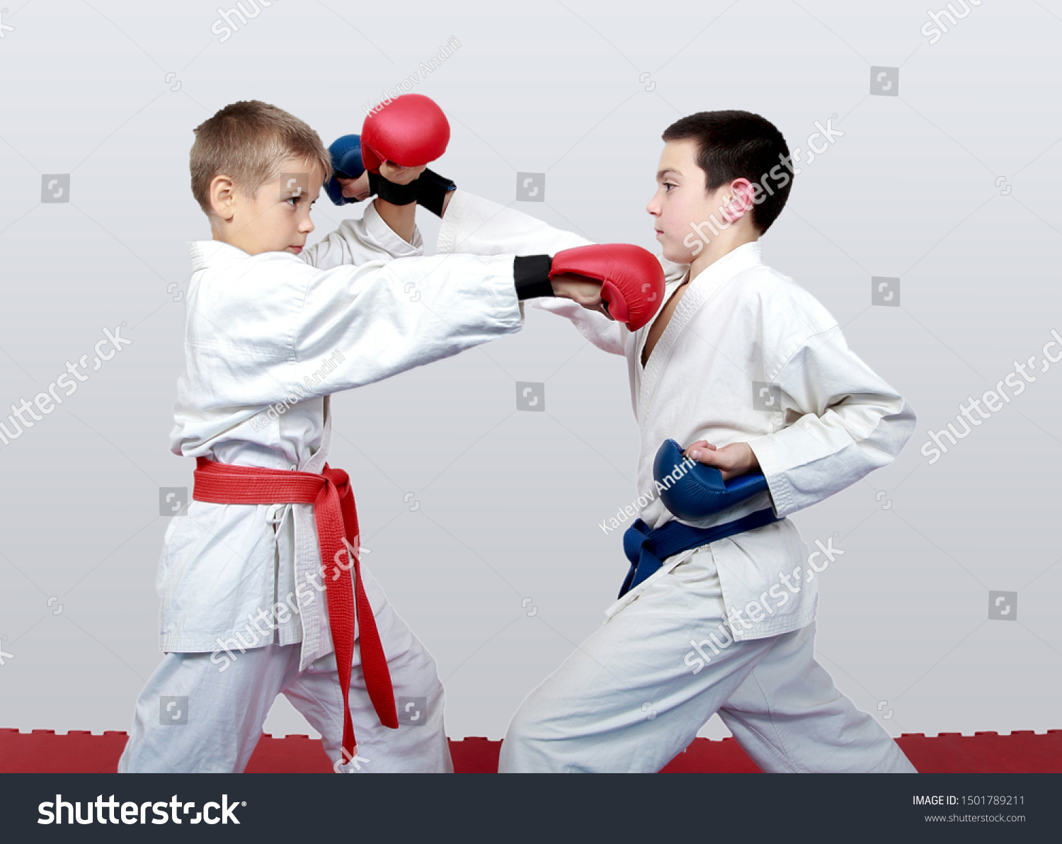 With blue and red belt boys train paired exercises karate #1501789211
