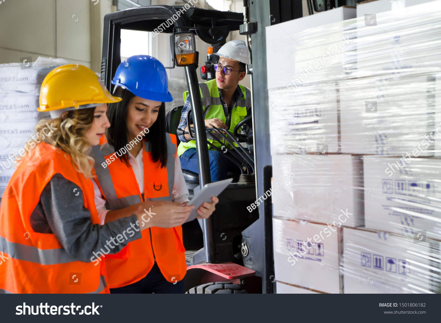Female workers using a digital pc tablet in the factory warehouse #1501806182