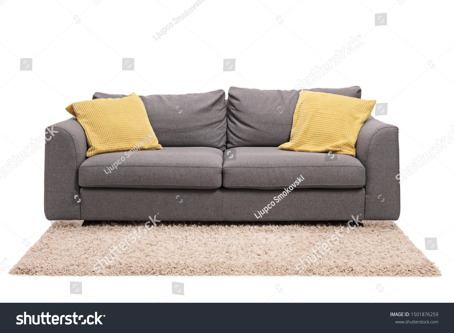 Studio shot of a grey sofa with green pillows on a carpet isolated on white background #1501876259