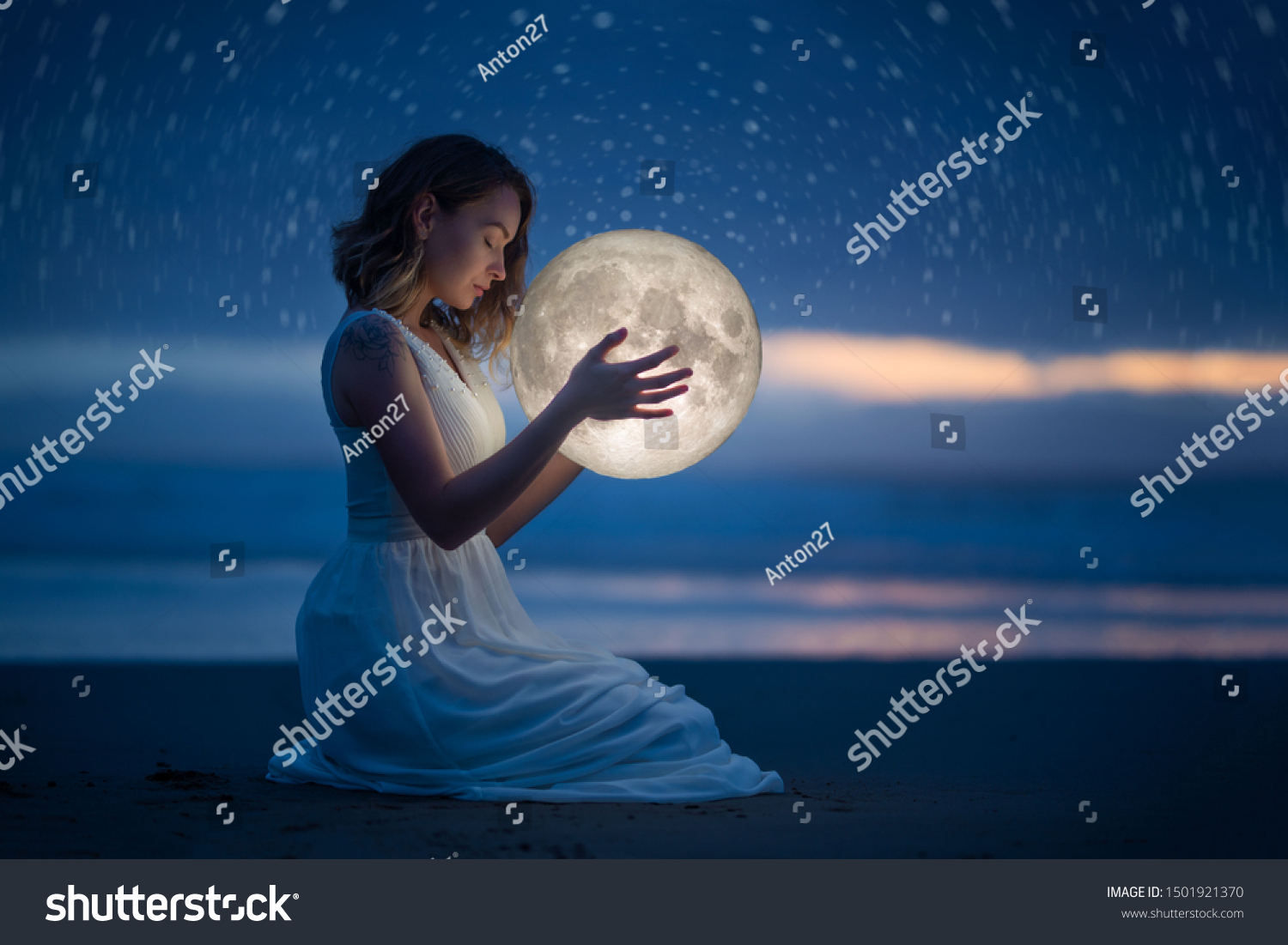 Delicate photography, Astrology, Women's magic. Beautiful attractive girl on a night beach with sand and stars hugs the moon, art photography. #1501921370