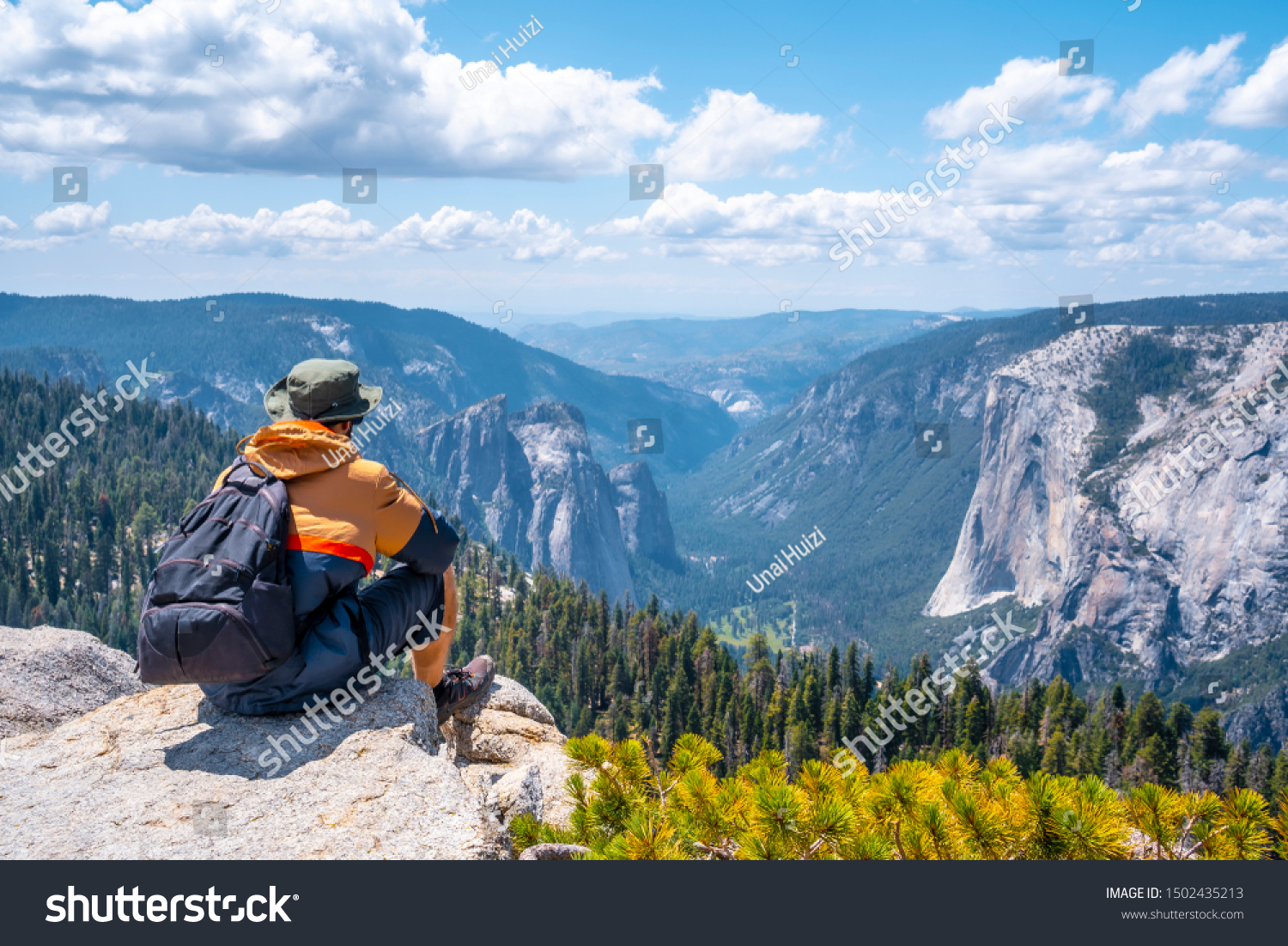 A young man sitting at the Sentinel Dome viewpoint in Yosemite National Park. United States #1502435213