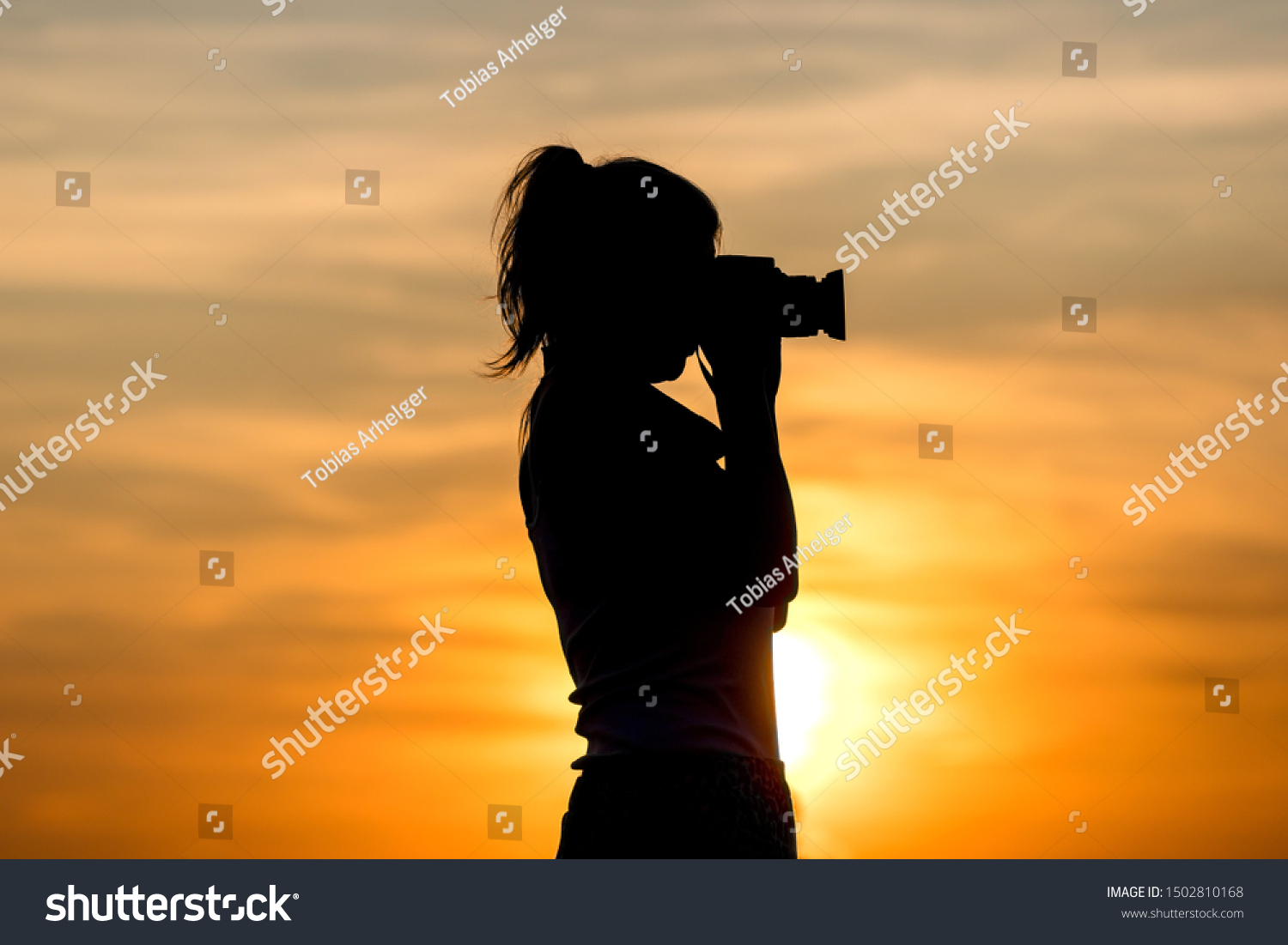 a photographer woman sundown shadow #1502810168