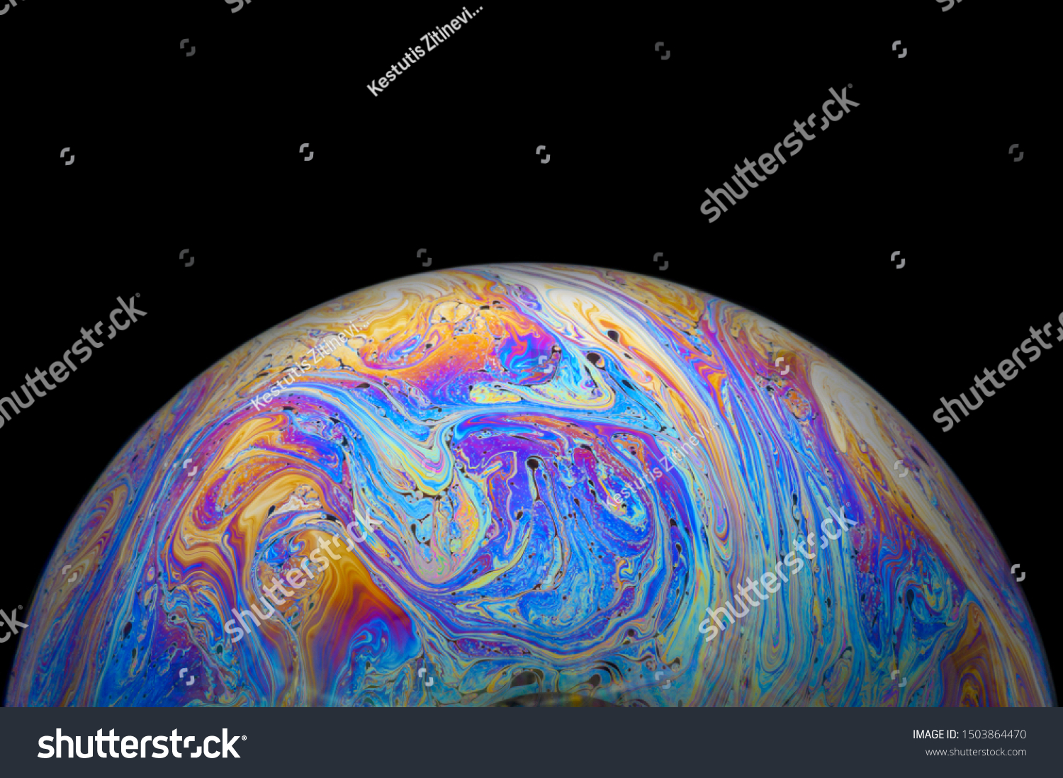 Abstract Soap bubble macro photo with black background look like planet #1503864470