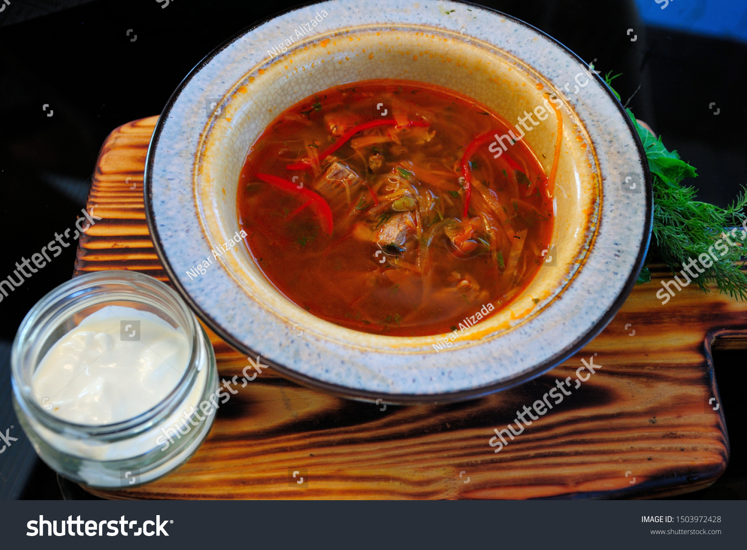 Traditional Russian borsch soup with fried carp made in Mordovian style and served with smetana sour cream #1503972428