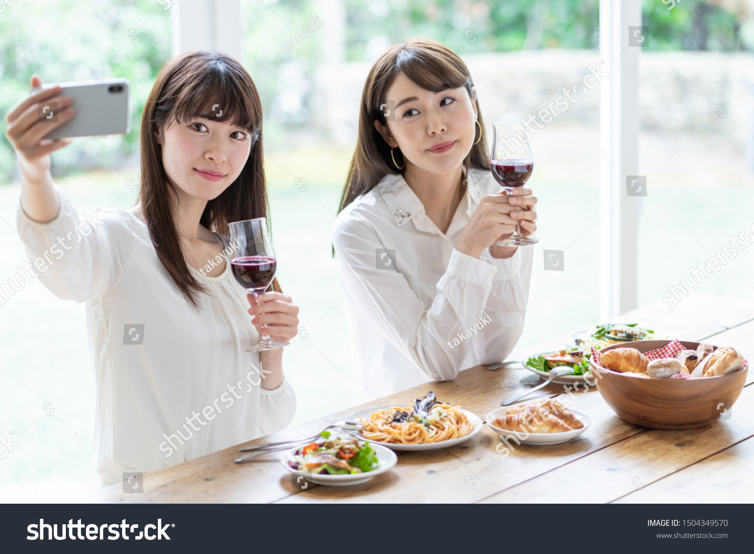 attractive asian women enjoying lunch in living room #1504349570