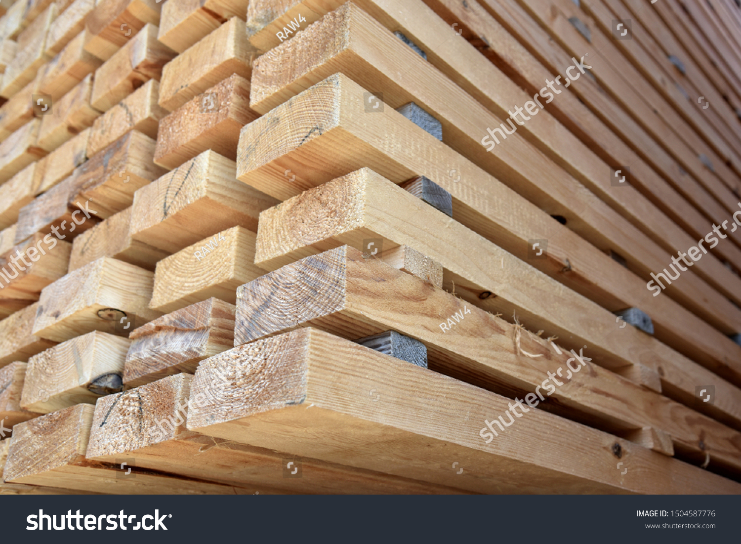 The end part of the dried wooden beam is piled in a pile in the warehouse. #1504587776