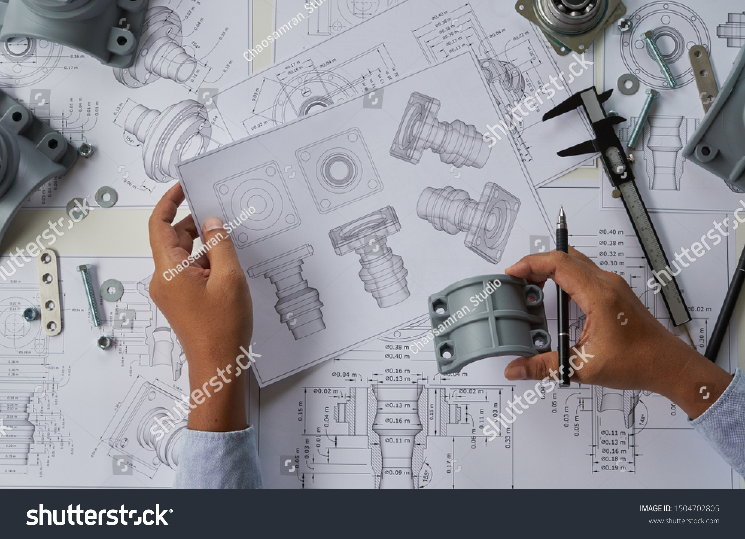Engineer technician designing drawings mechanical parts engineering Engine
manufacturing factory Industry Industrial work project blueprints measuring bearings caliper tools #1504702805