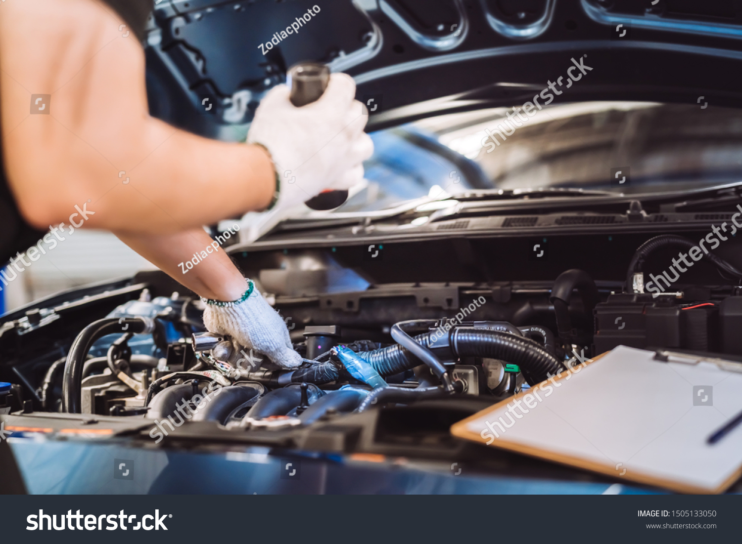 Mechanic man examining and maintenance to customer the engine a vehicle car hood, Safety inspection test engine before customer drive on a long journey, transportation repair service center #1505133050