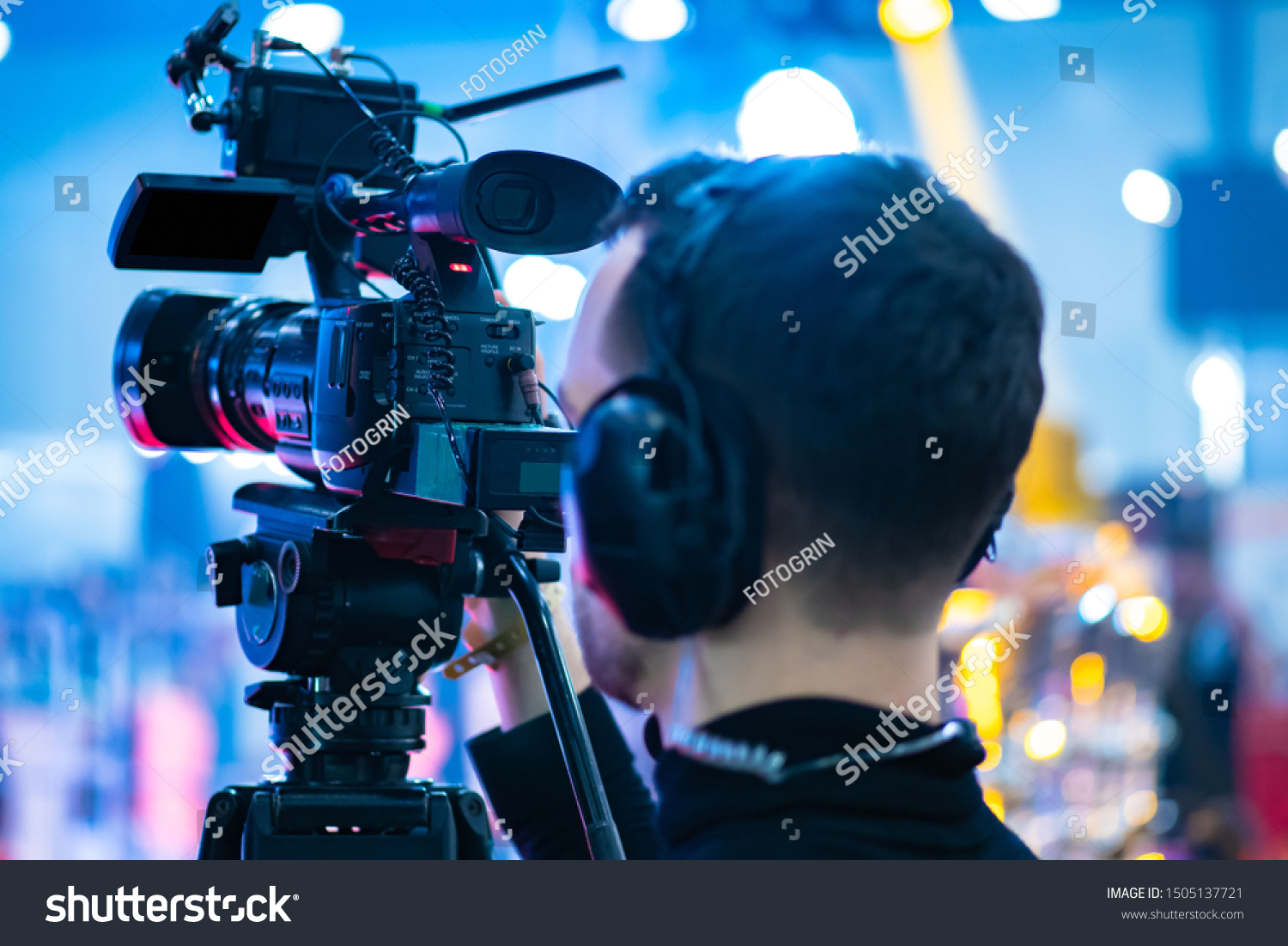 Video operator. Videography.Filming.A man is shooting a video.The work of a videographer. Shooting with a professional camera with a tripod. A man shoots on a professional video camera.Videographer #1505137721