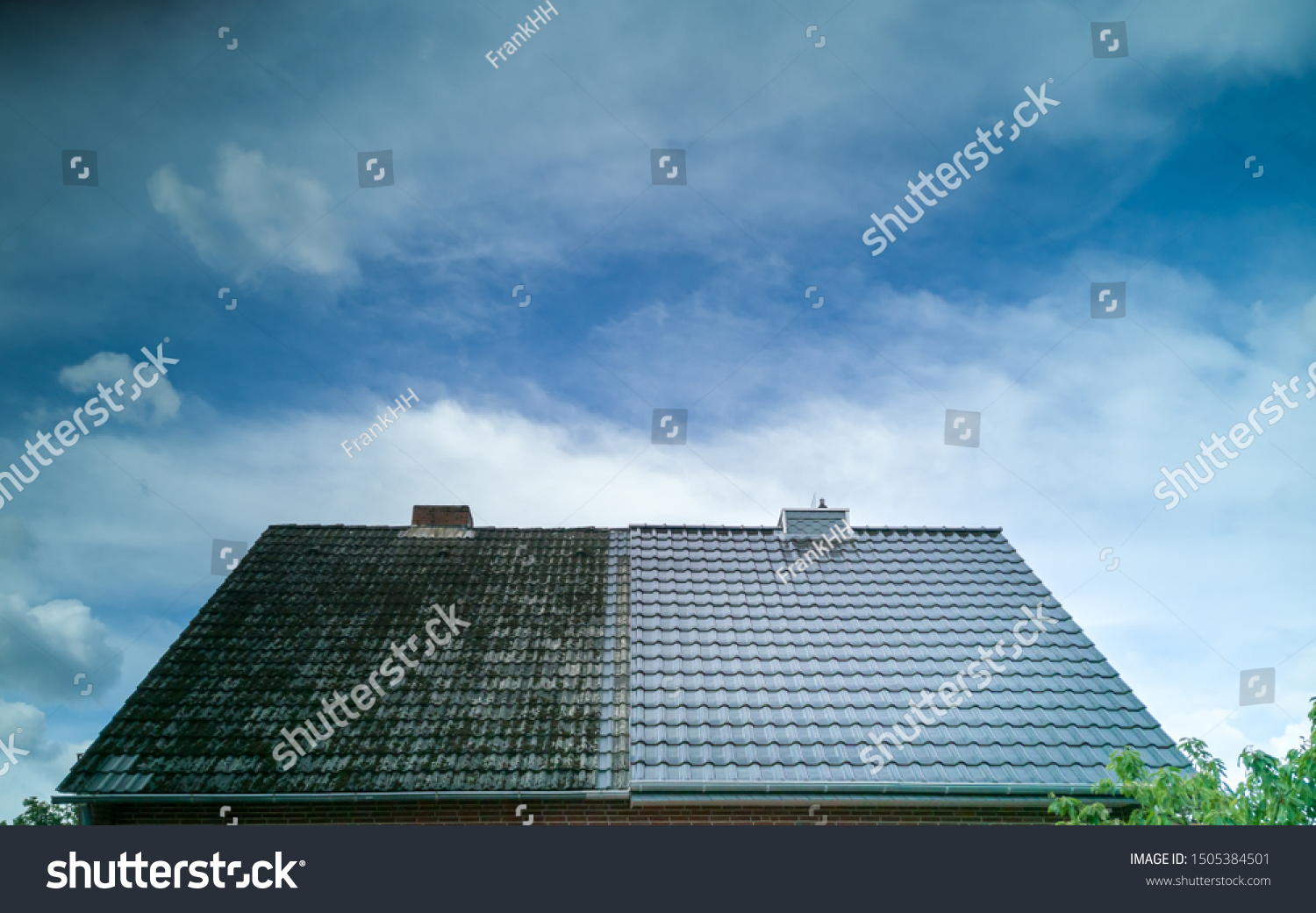 A half cleaned house roof shows the before and after effect of a roof cleaning. #1505384501