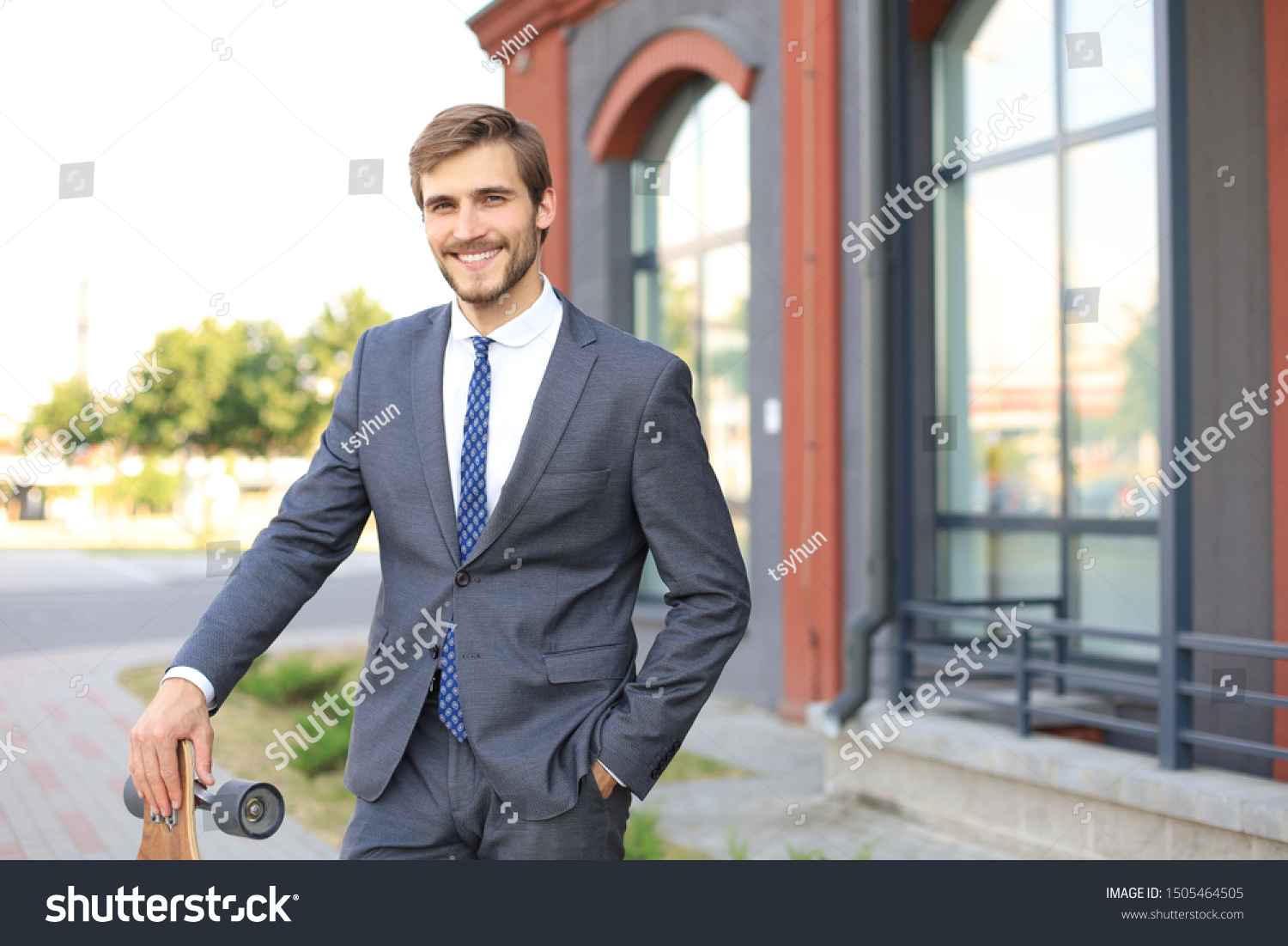 Confident young businessman walking on the street, using longboard. #1505464505