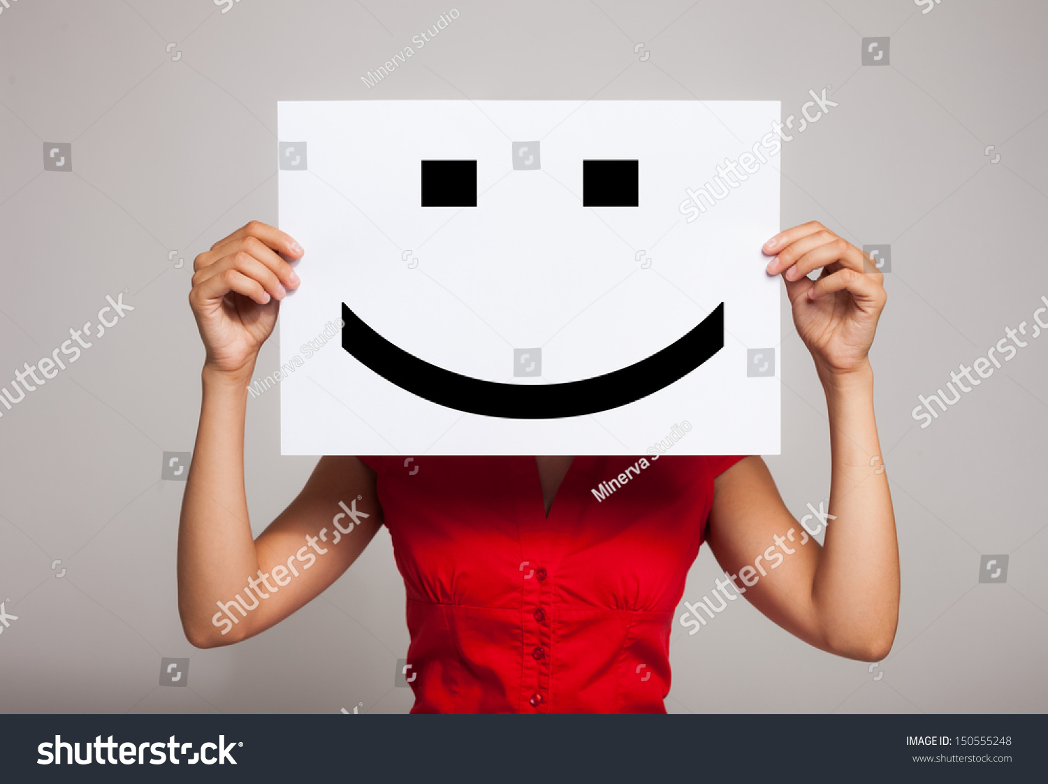 Woman holding a smiling face emoticon #150555248