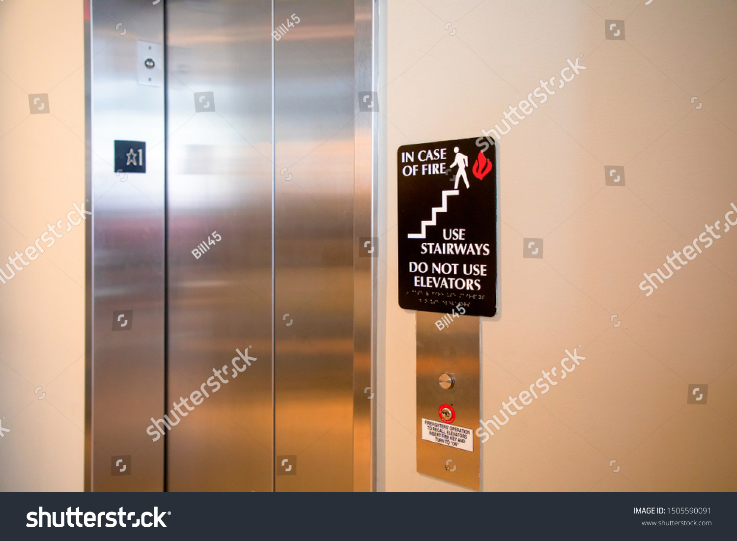 Do not use elevator in case of fire sign beside the elevator. safety concept. #1505590091