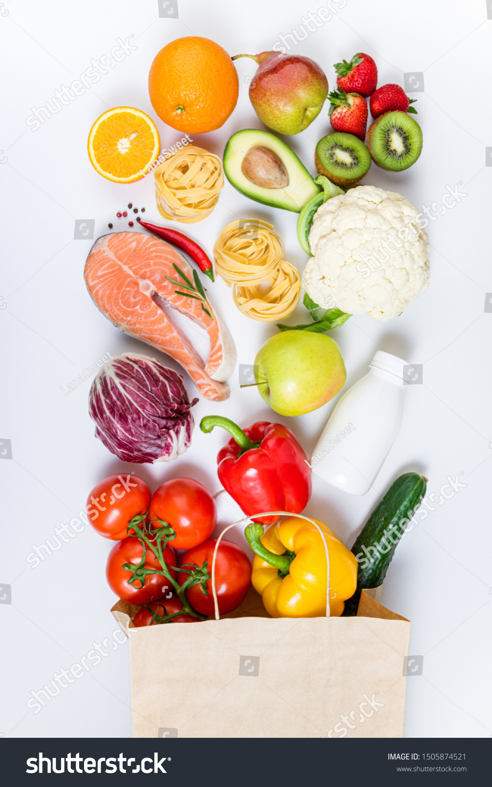 Healthy food background. Healthy food in paper bag fruits, vegetables, milk, pasta and fish on white background. Shopping food supermarket, meal and nutrition plan concept. Top view #1505874521