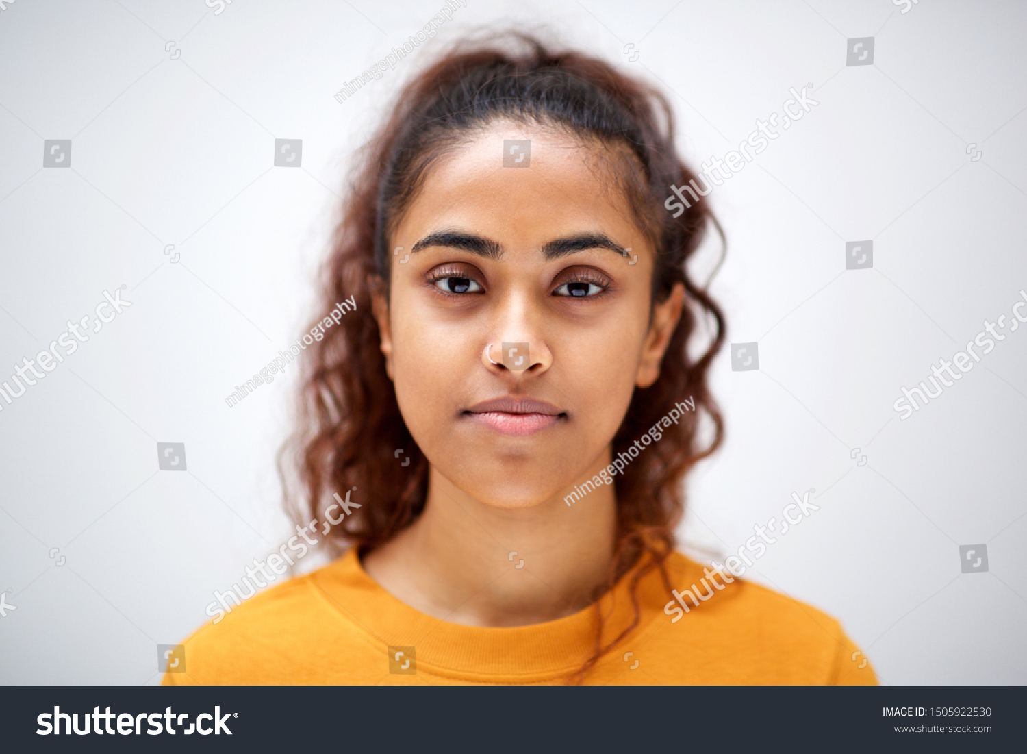 Close up horizontal front portrait of attractive young indian woman with serious expression on face #1505922530