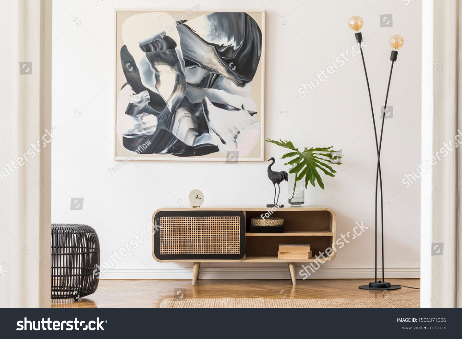 Stylish scandinavian living room interior with modern wooden commode, stylish lamps, plants, rattan basket, sculpture and elegant personal accessories. Mock up paintings on the white wall. Template.  #1506371006