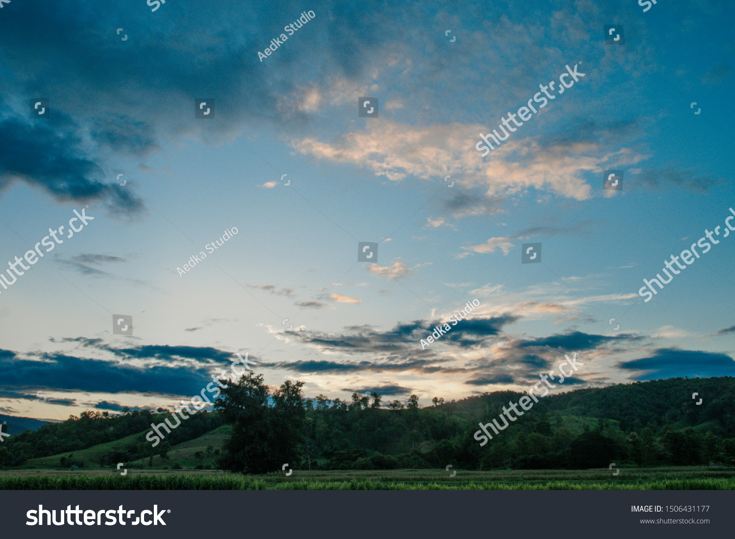 Colorful cloudy sky after rain, Beautiful evening skyscape. Sun's rays shine through hole in black clouds after rain. Sky, Golden sky. Natural background. Inspirational concept. #1506431177