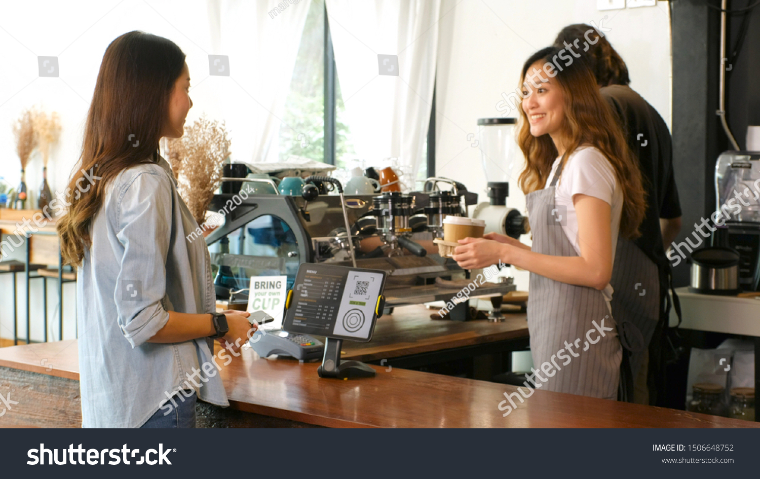 Young asian barista woman serving take out coffee cup to customer at counter in cooffee shop cafe background, asia small business owner, start up #1506648752