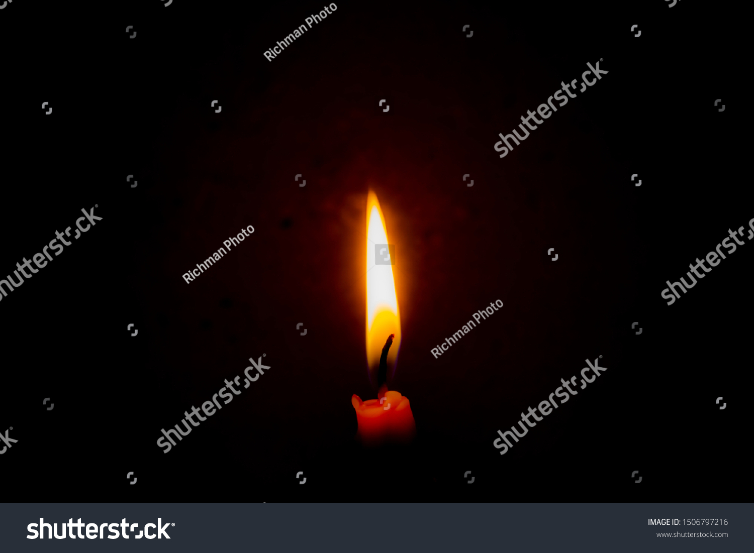 Closeup burning candle in the dark with a dark background. Dark key photo. #1506797216
