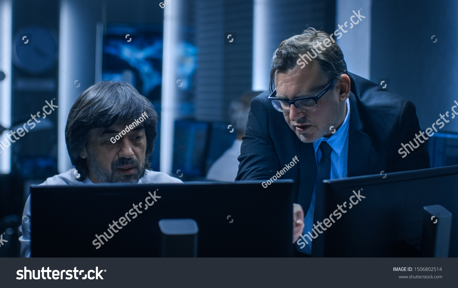 Government Chief of Cyber Security Consults Operations Officer who Works on Computer. Specialists Working on Computers in System Control Room. #1506802514