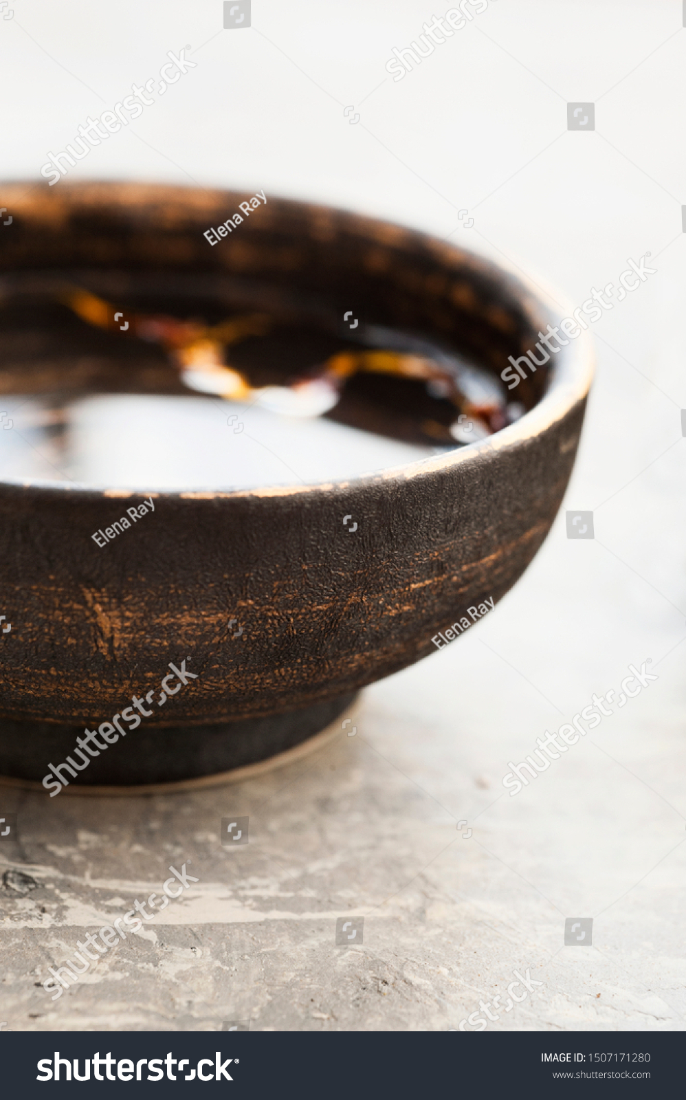Pure water with organic leaf elements in a beautiful ceramic bowl. Still Life Photography. #1507171280
