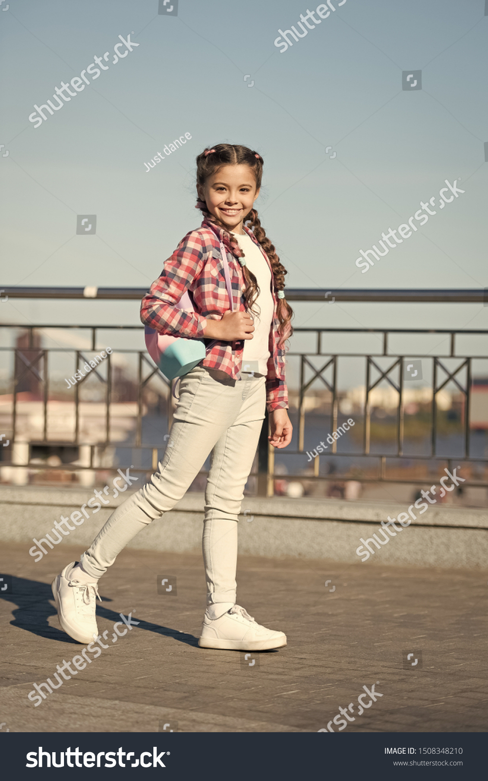 The street style way. Little cute child with beautiful long braided hair style. Adorable small girl in casual style on summer day. Owning her style. #1508348210