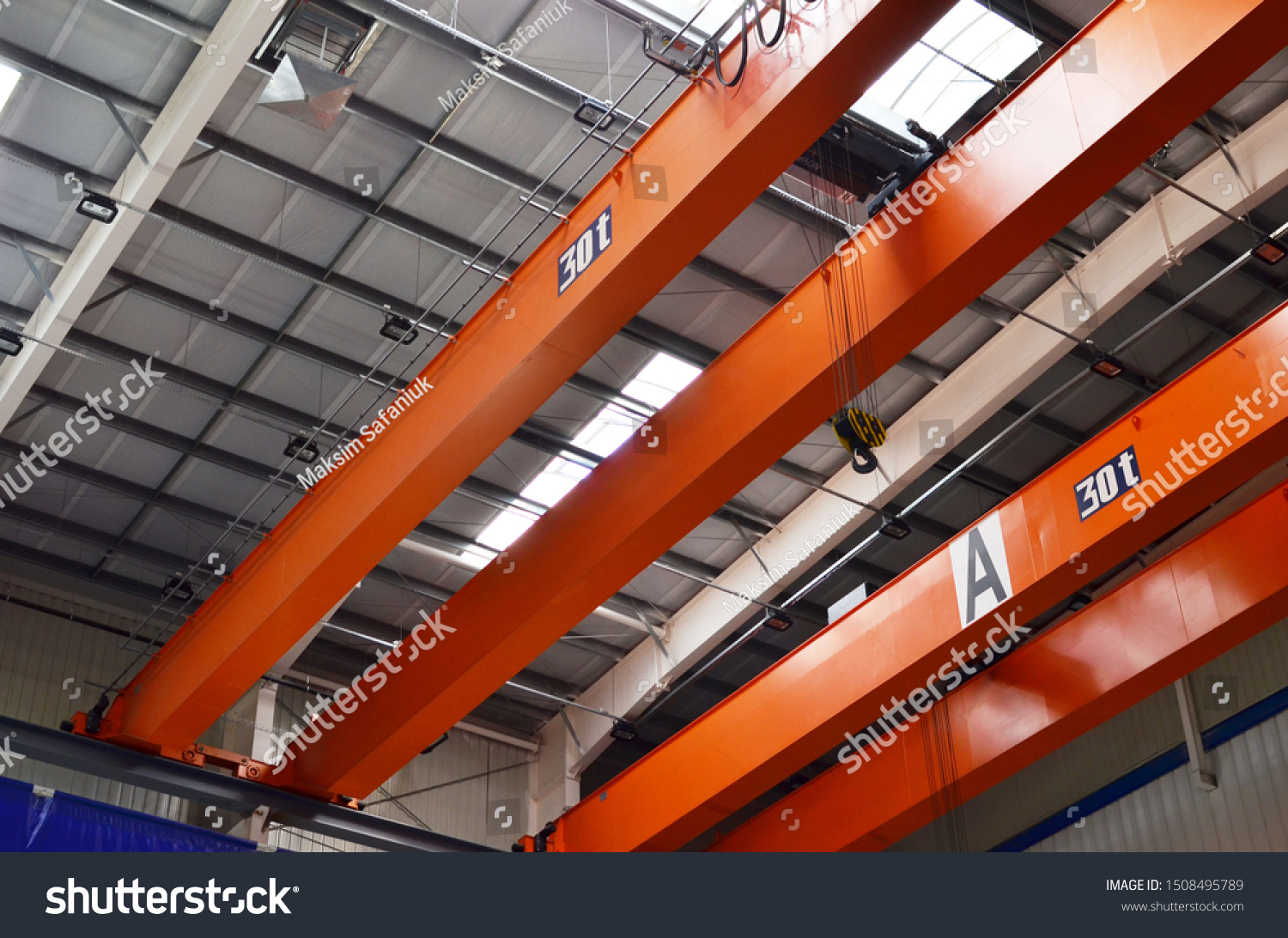 Bridge lifting Crane Hook with electric engines on the background of the industrial workshop production plant. The concept of a heavy manufacturing process at an industrial factory #1508495789