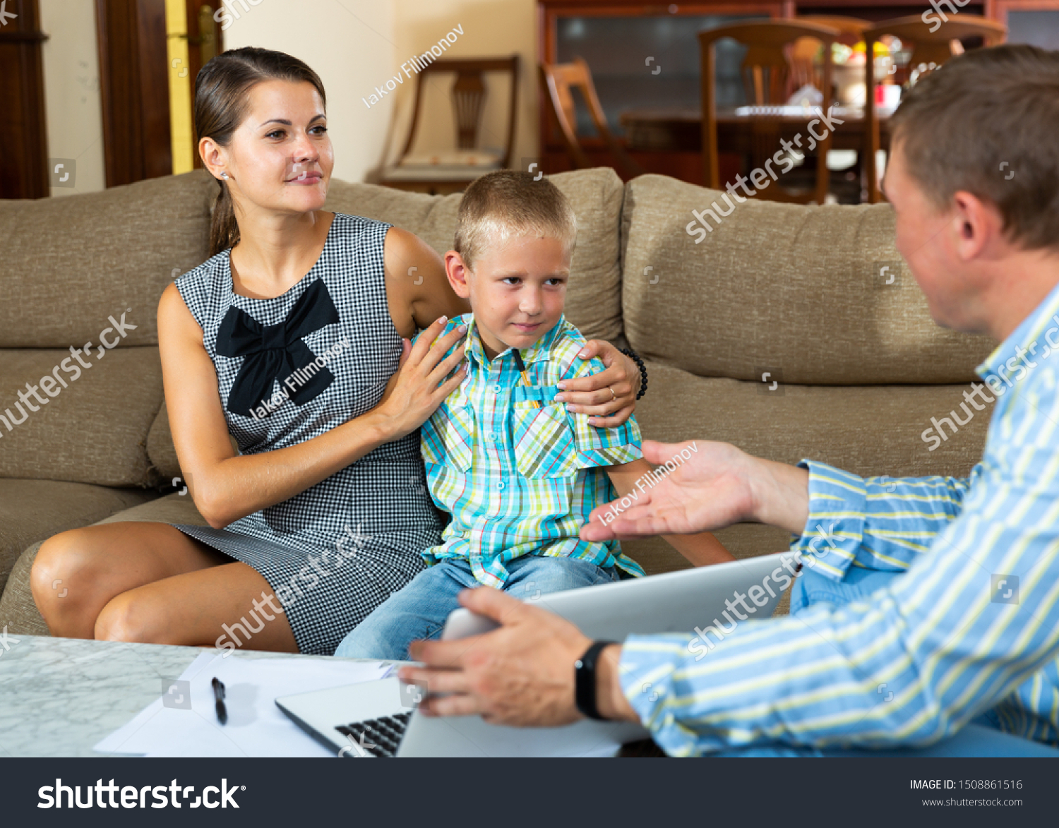 Professional consultant making presentation with laptop for woman with little son at home #1508861516