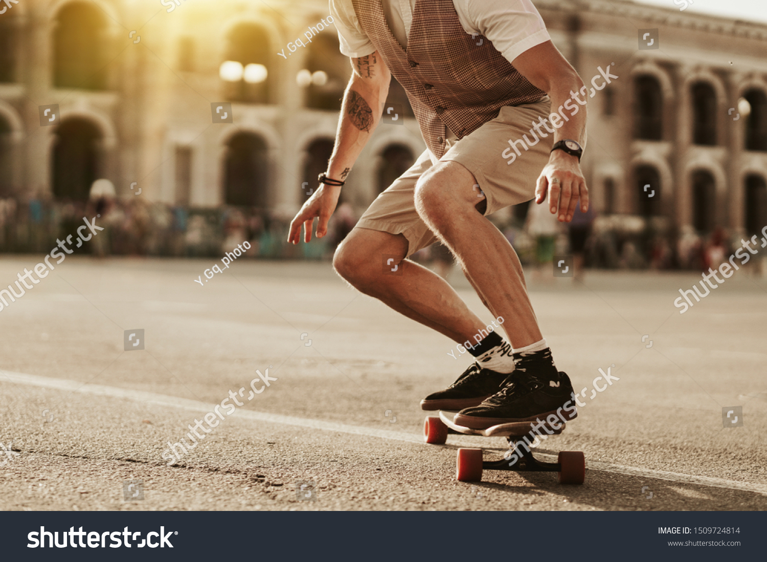 Urban man lifestyle. Stylish man ride on skateboard in white shirt on city street. Portrait of handsome bearded hipster male near road on buildings background. #1509724814