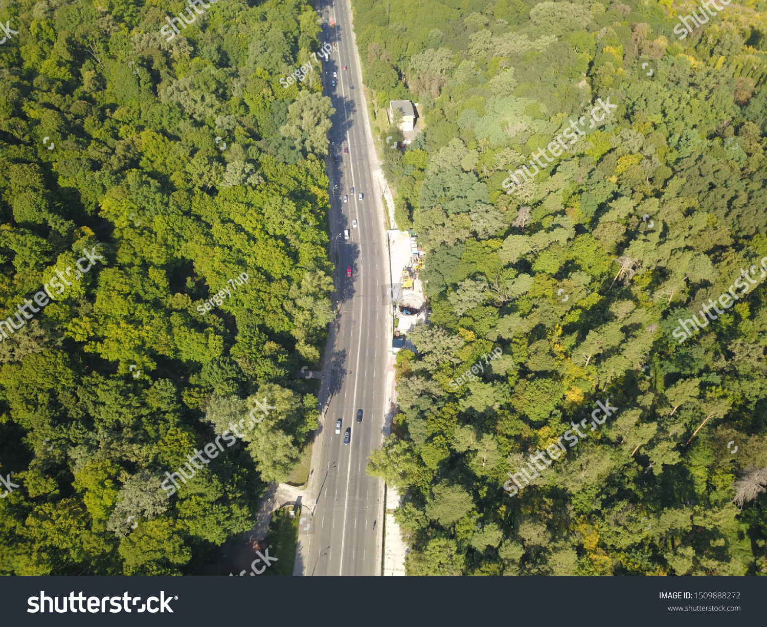 Aerial view. The road through the green forest. #1509888272