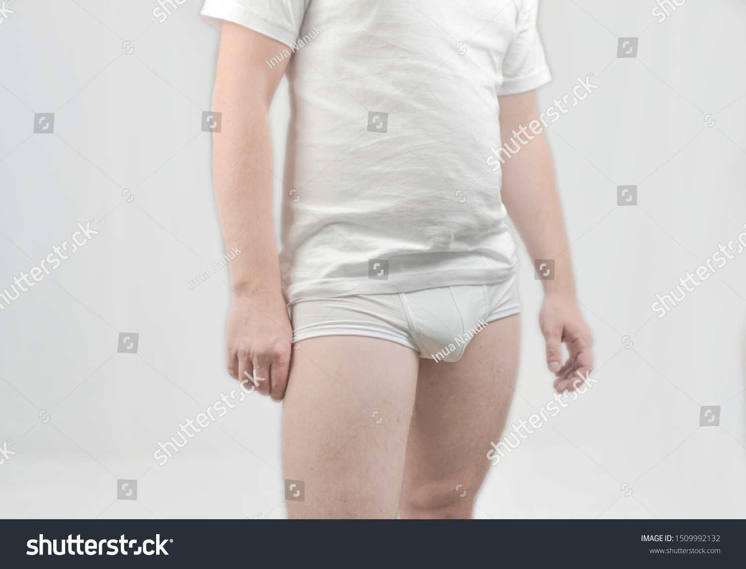 A guy standing in white shorts and a white T-shirt #1509992132