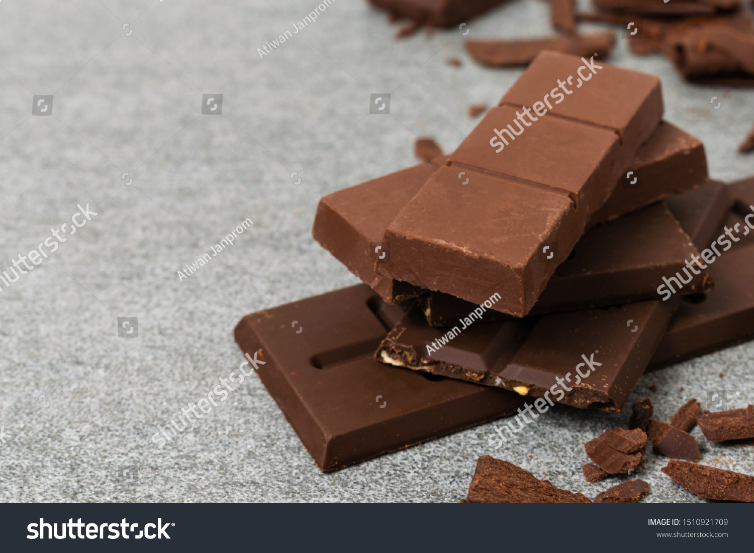 Broken chocolate with small piece on tile table. #1510921709