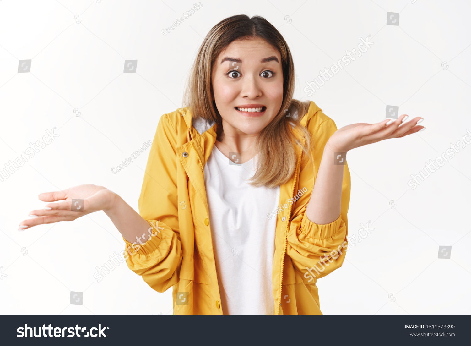 Yikes sorry not knew. Awkward cheerful blond asian woman shrugging hands spread sideways unaware questioned perplexed answer clench teeth uncertain expression clueless say, white background #1511373890