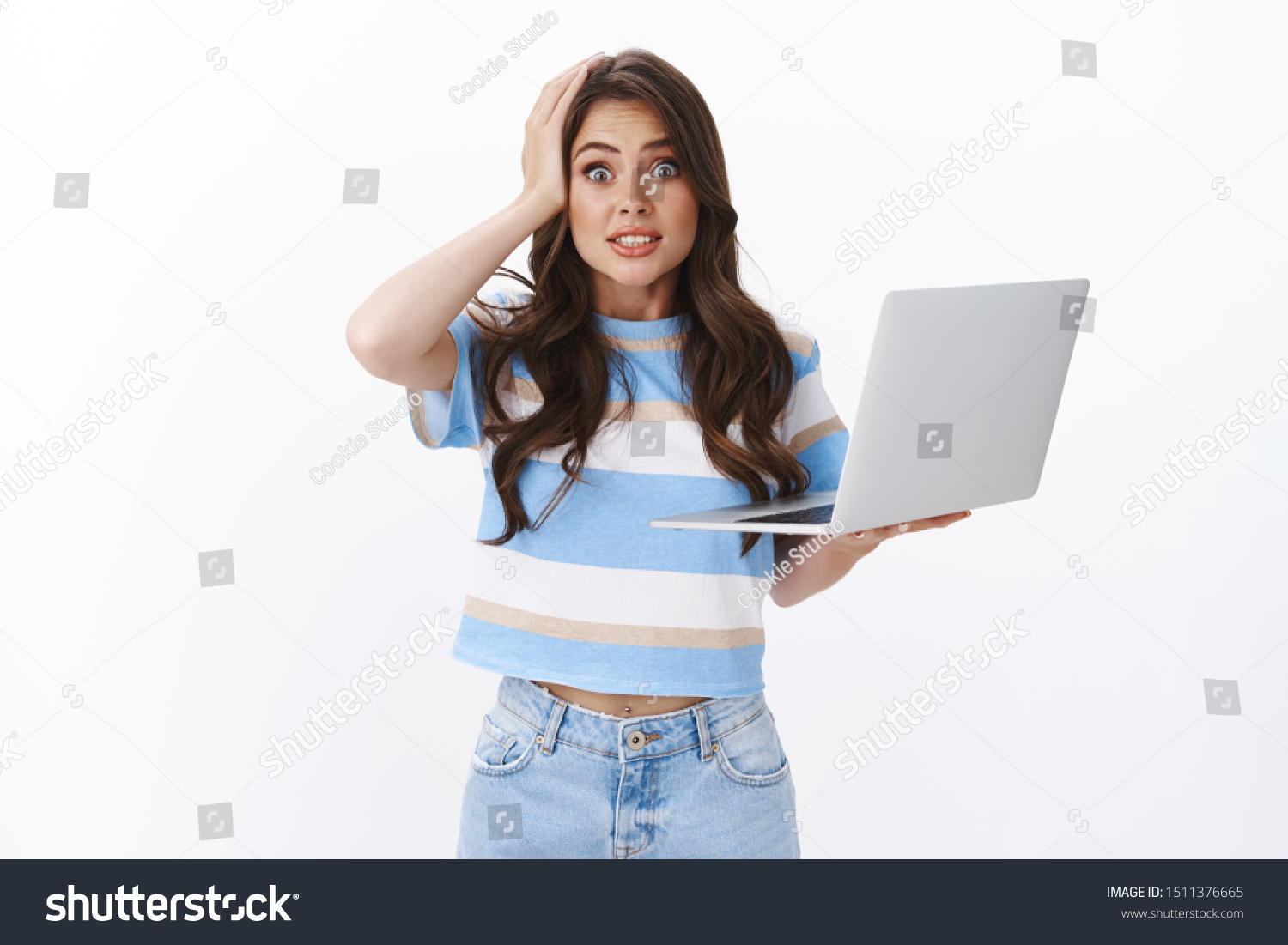 Oops my fault. Clumsy cute and silly woman brunette with curly long haircut, hold laptop, say yikes stare camera grab head, making mistake, have slight accident, apologizing white background #1511376665
