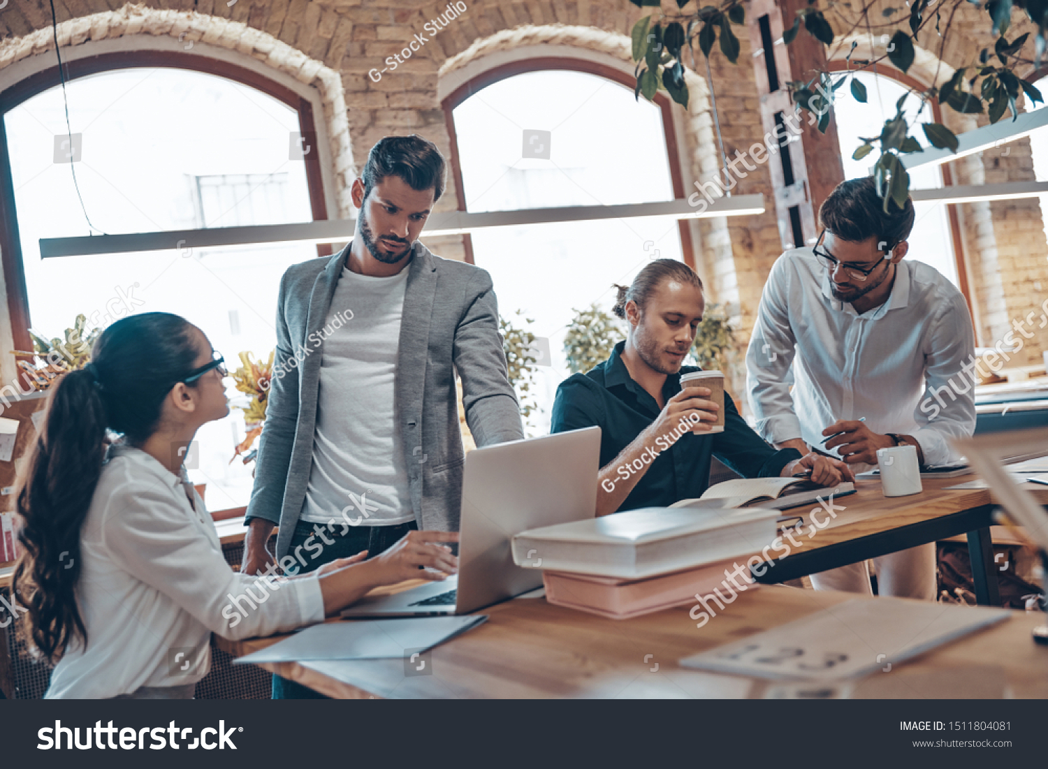 Group of young modern people in smart casual wear talking business ideas while working in the office                        #1511804081