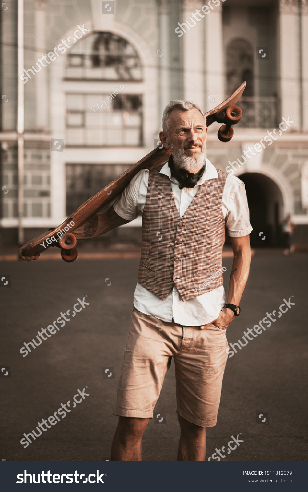 Adult bearded man portrait with longboard. Stylish model in casual clothes ride skateboard on city street background. Outdoors style. Sport lifestyle #1511812379