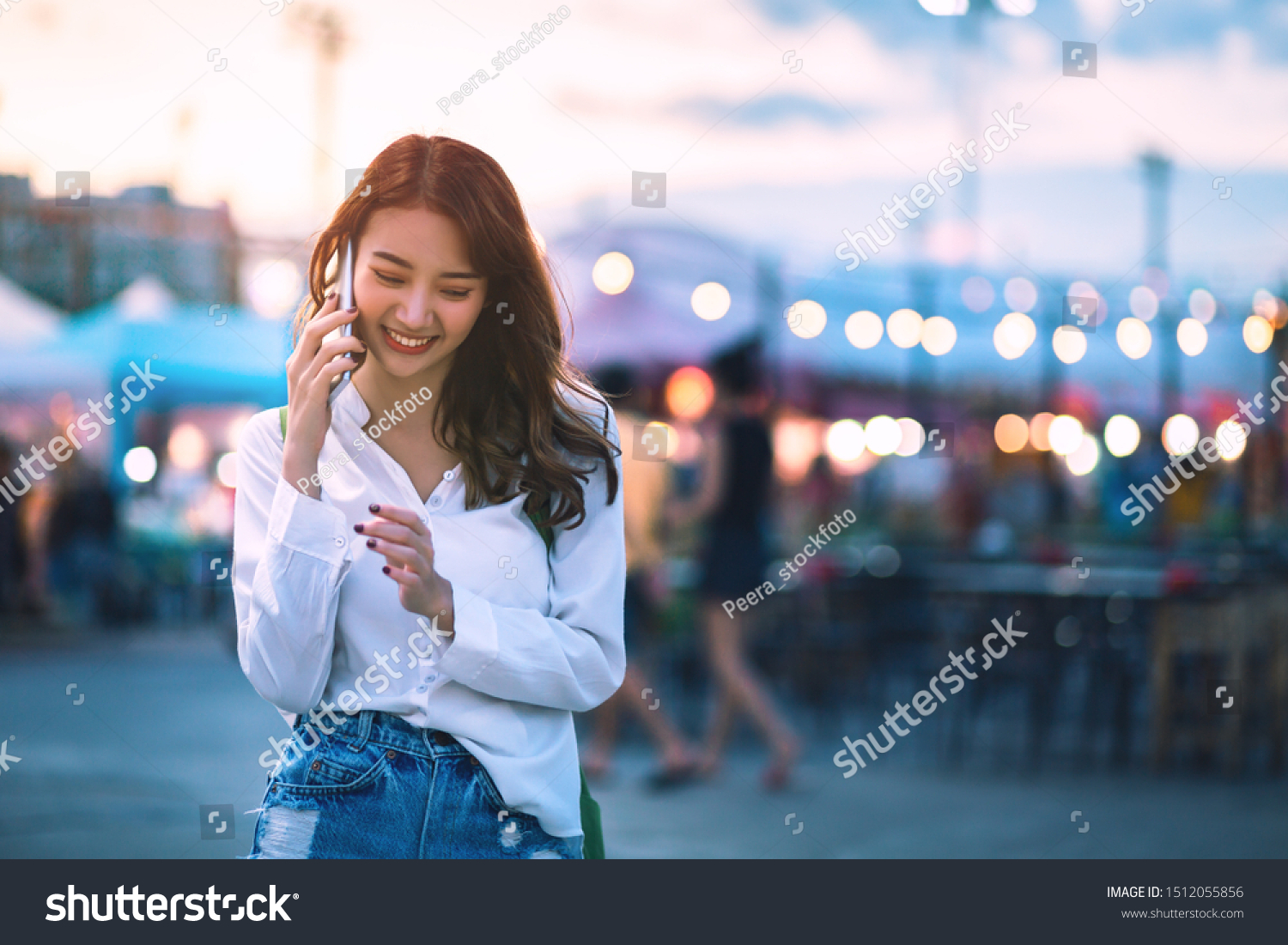Happy young travel asian woman using smartphone and relax on street market against light bokeh background at dusk in Bangkok, Thailand, Travel vacation city concept #1512055856