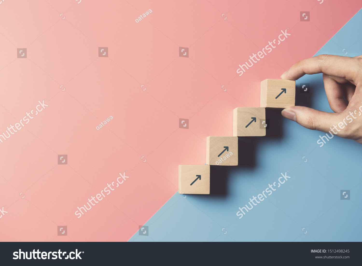 Business concept growth success process, Close up man hand arranging wood block stacking as step stair on paper blue and pink background, copy space. #1512498245