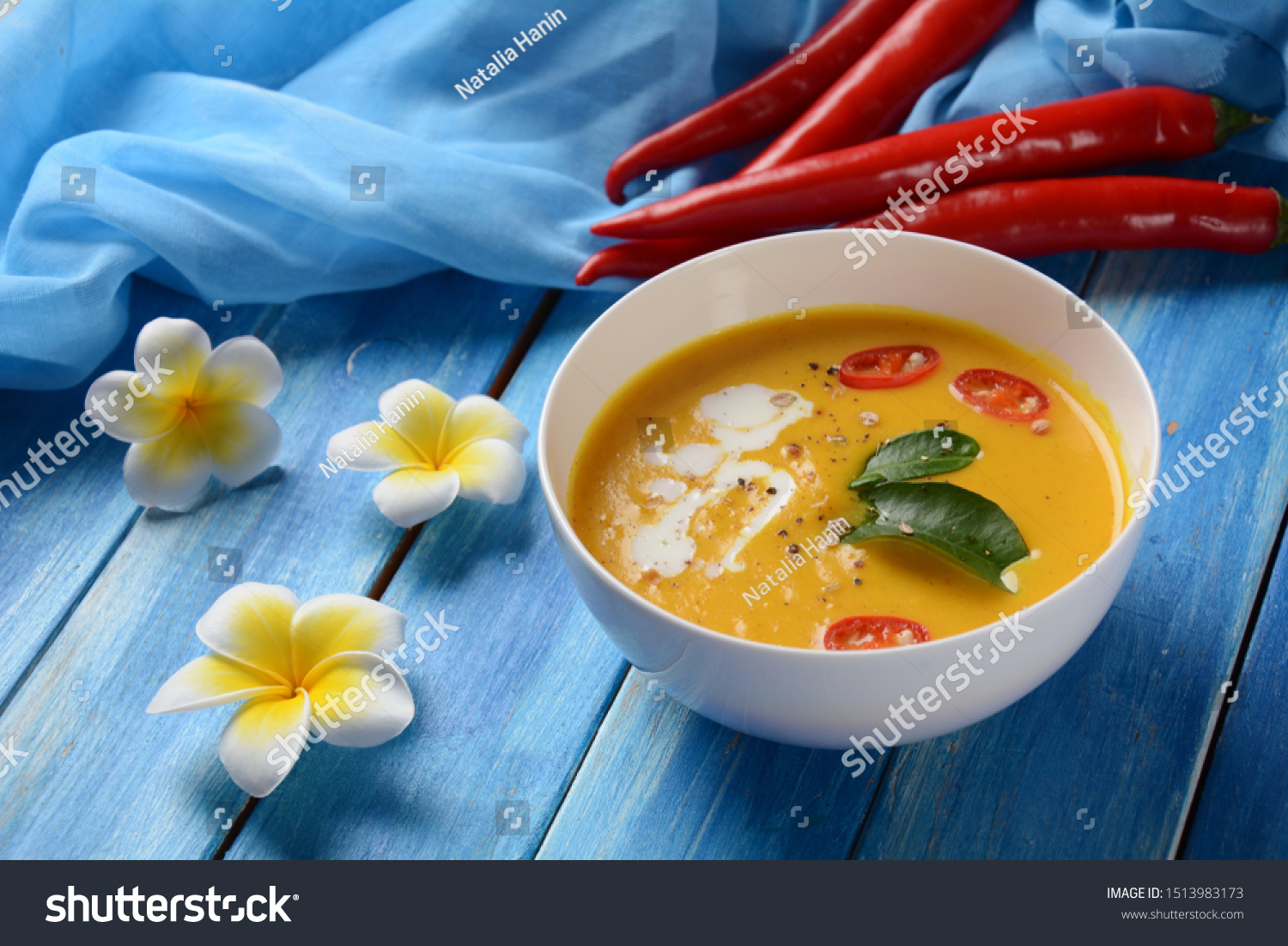 Thai spicy pumpkin and coconut milk soup with kaffir lime leaves , red chilli and galangal roots powder. Vegan, healthy food, gluten-free. Paleo- diet #1513983173