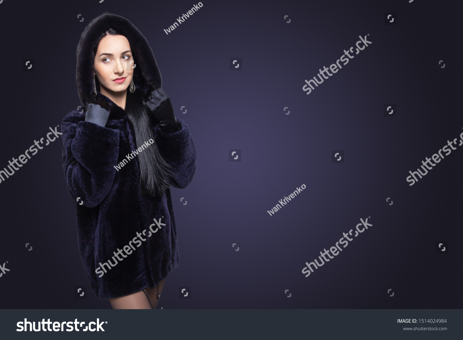 Beauty Fashion Model Girl in Blue Mouton Fur Coat. Beautiful Luxury Winter Woman in short coat with hood on blue background with copy space. #1514024984
