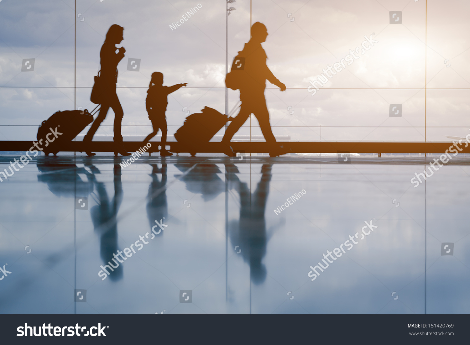 Silhouette of young family with luggage walking at airport, girl showing something through the window #151420769