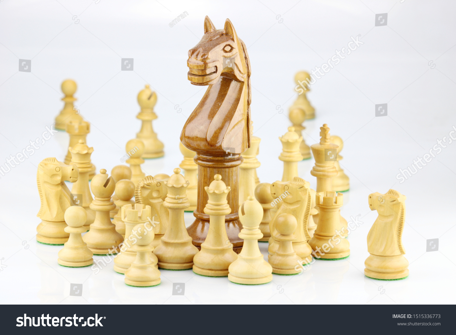 Chess pieces with an outstanding large knight in-focus leading the group that illustrate leadership, unity and teamwork concept #1515336773