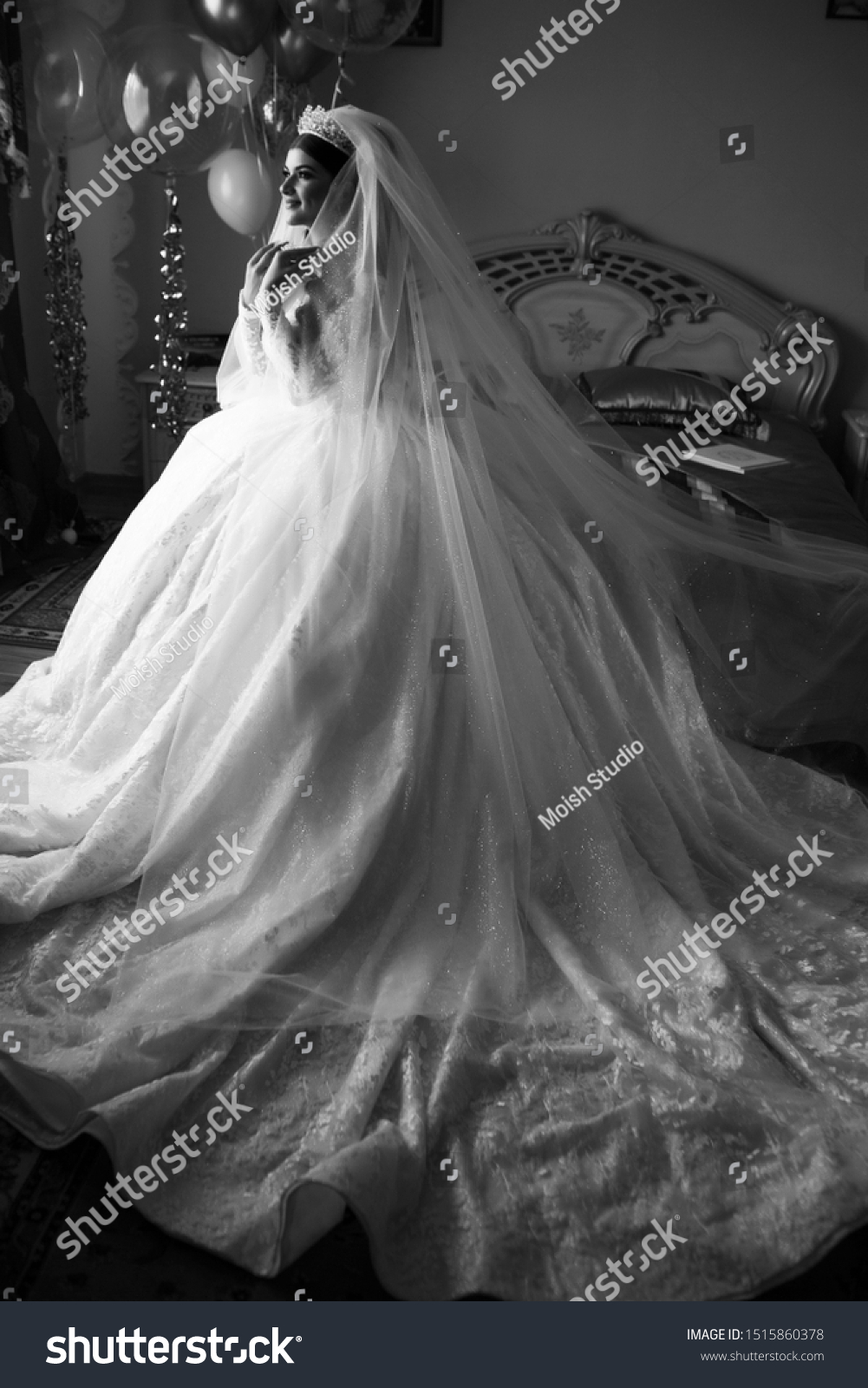 Kind of bride from the back, romantic atmosphere of the bride's morning. Beautiful bride in wedding dress. Bride in a home. Bride's morning. Bride morning preparation. Black and white #1515860378