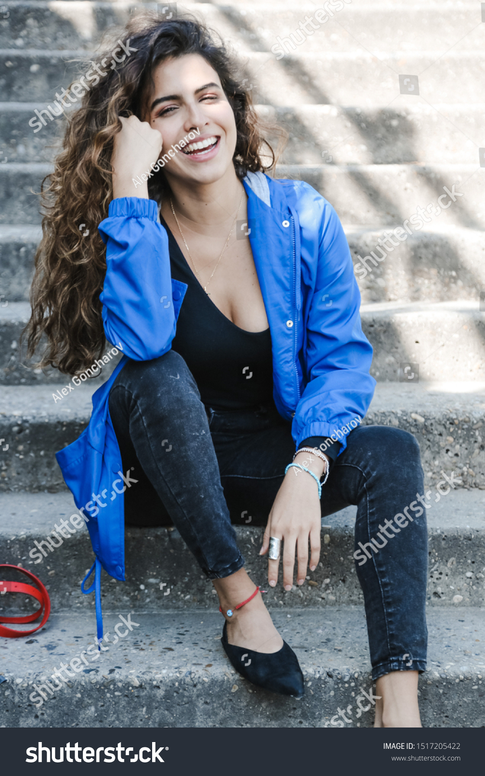 fashion portrait of a girl who sits on the steps #1517205422