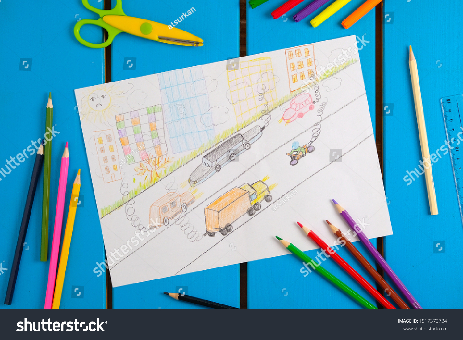 Child draws a pencil drawing of the city, cars and air pollution. Top view. #1517373734