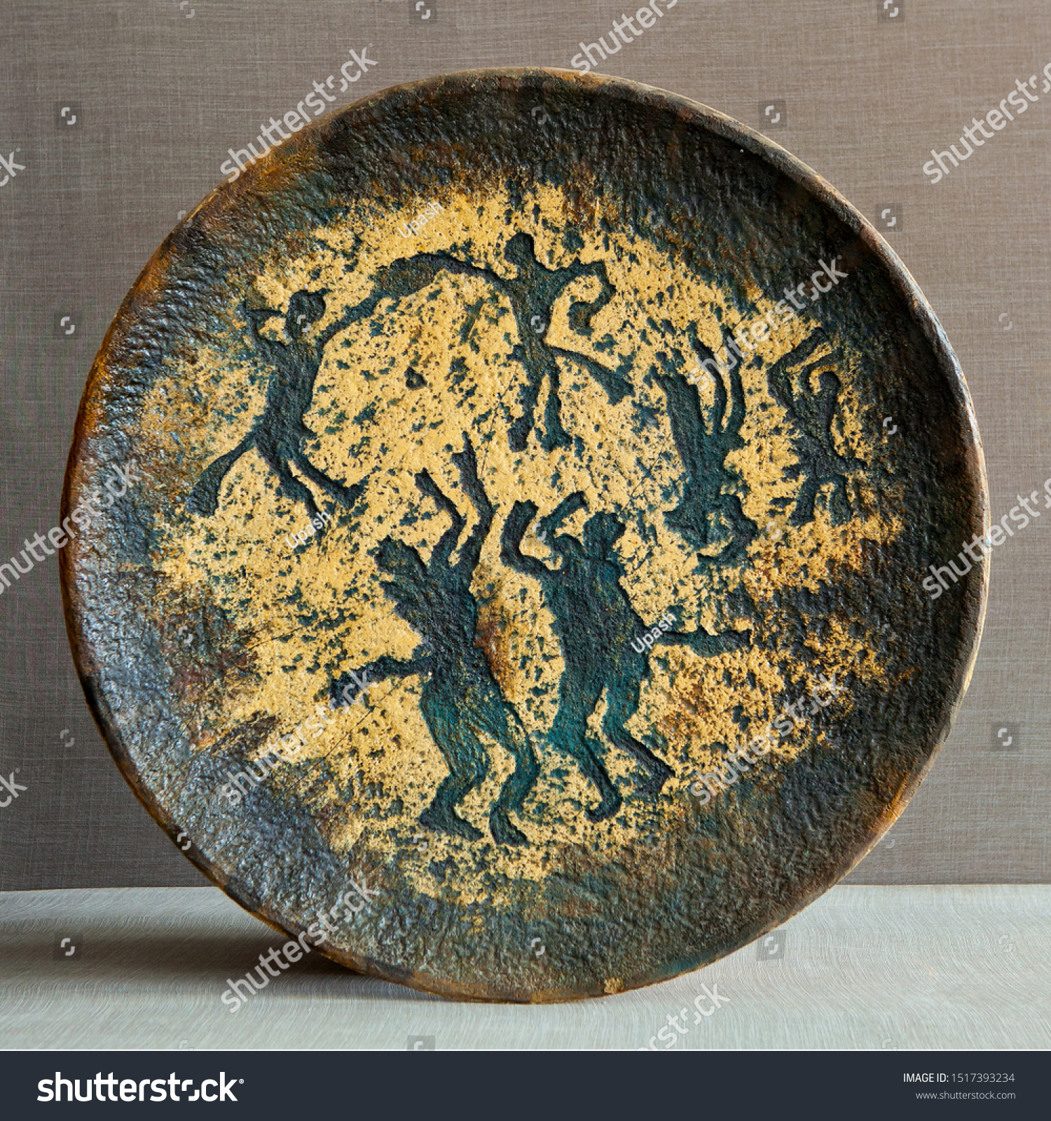 Ware from ceramics. Pictograms of nomadic peoples are displayed on the dishes. #1517393234