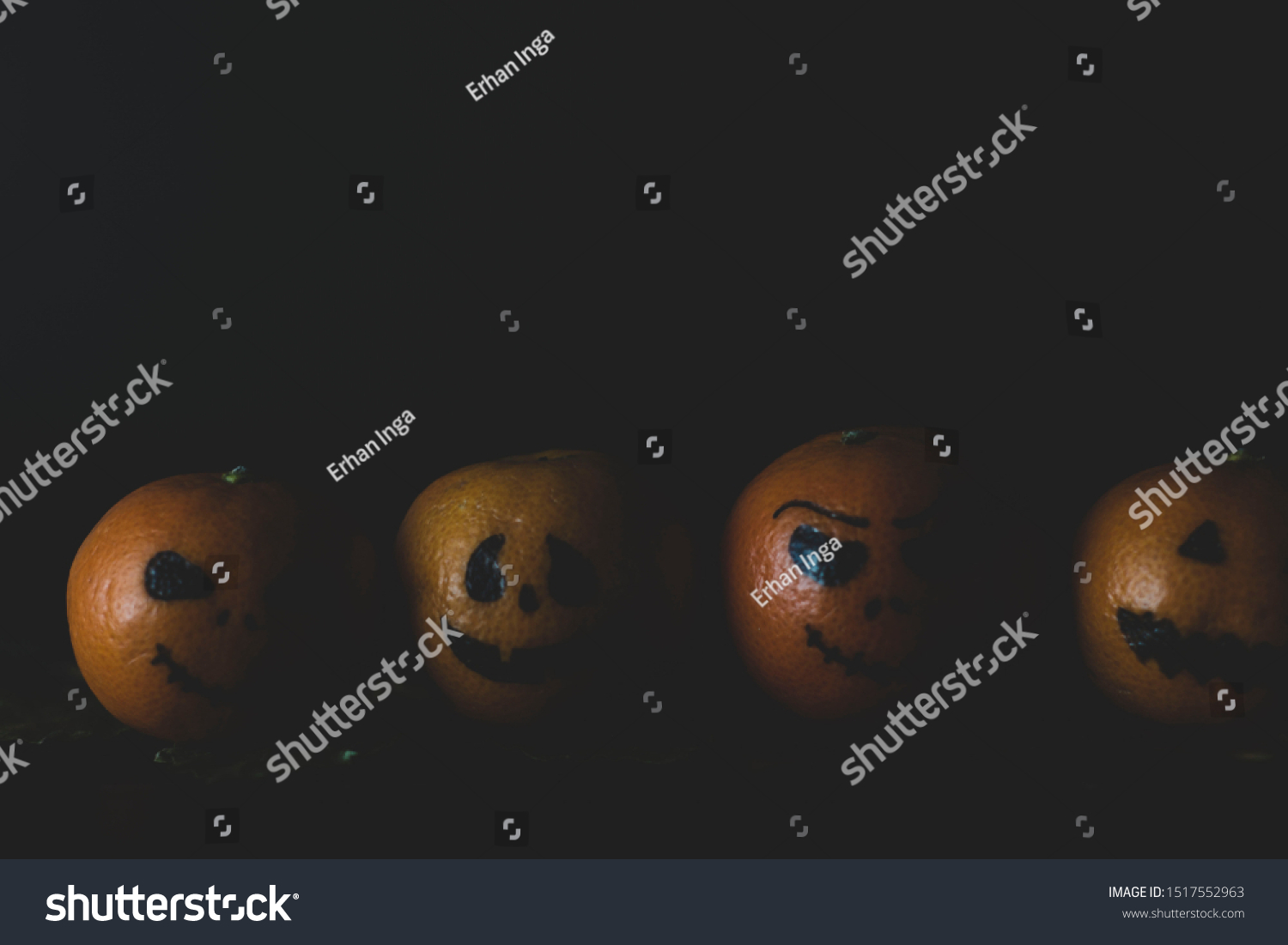 Happy Halloween citrus, tangerines painted with scary, funny faces. Dark photo with copy space for copy space. #1517552963