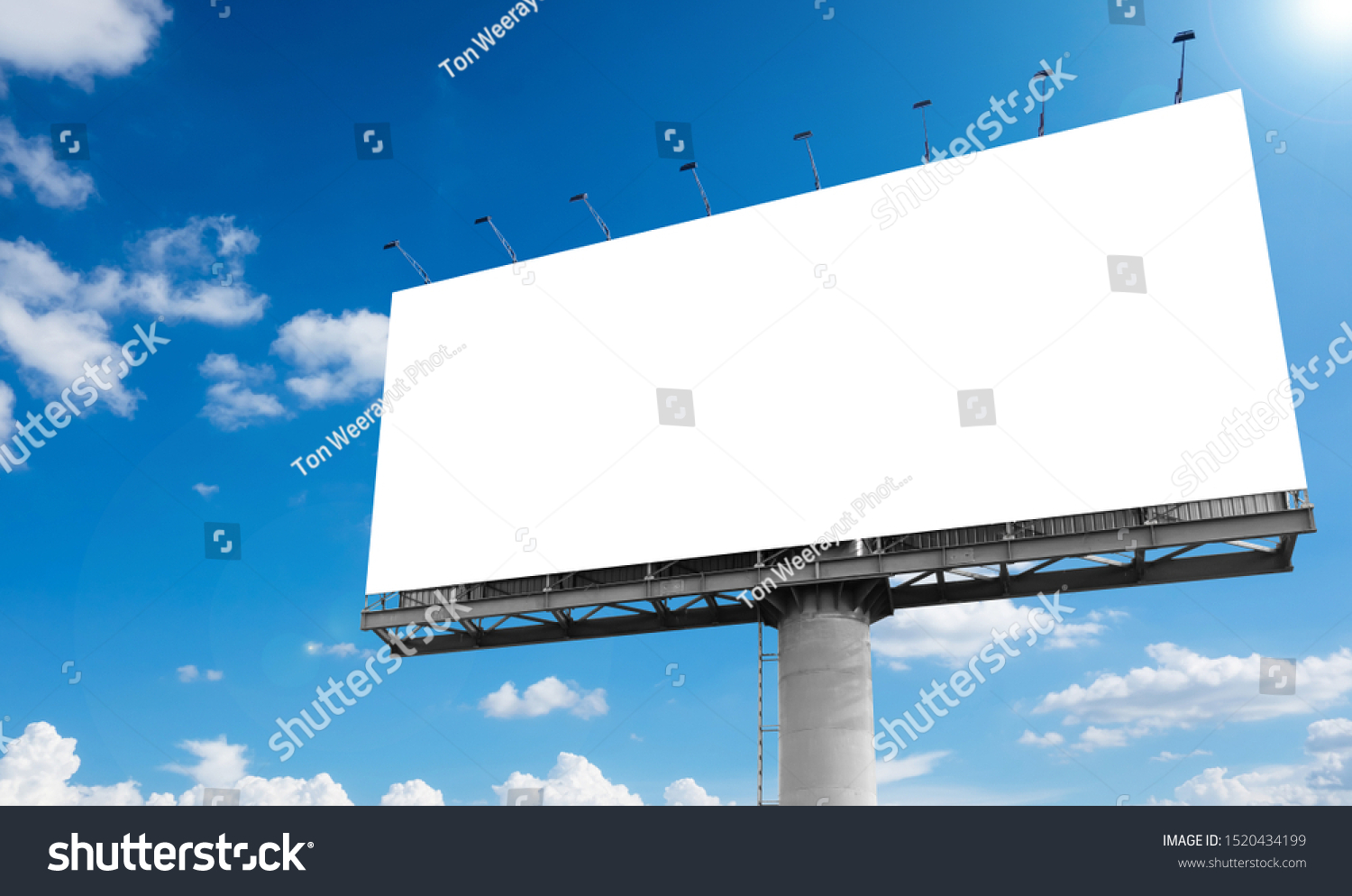 Mockup Large white blank billboard or white promotion poster displayed on the outdoor against the blue sky background. Promotion information for marketing announcements and details #1520434199