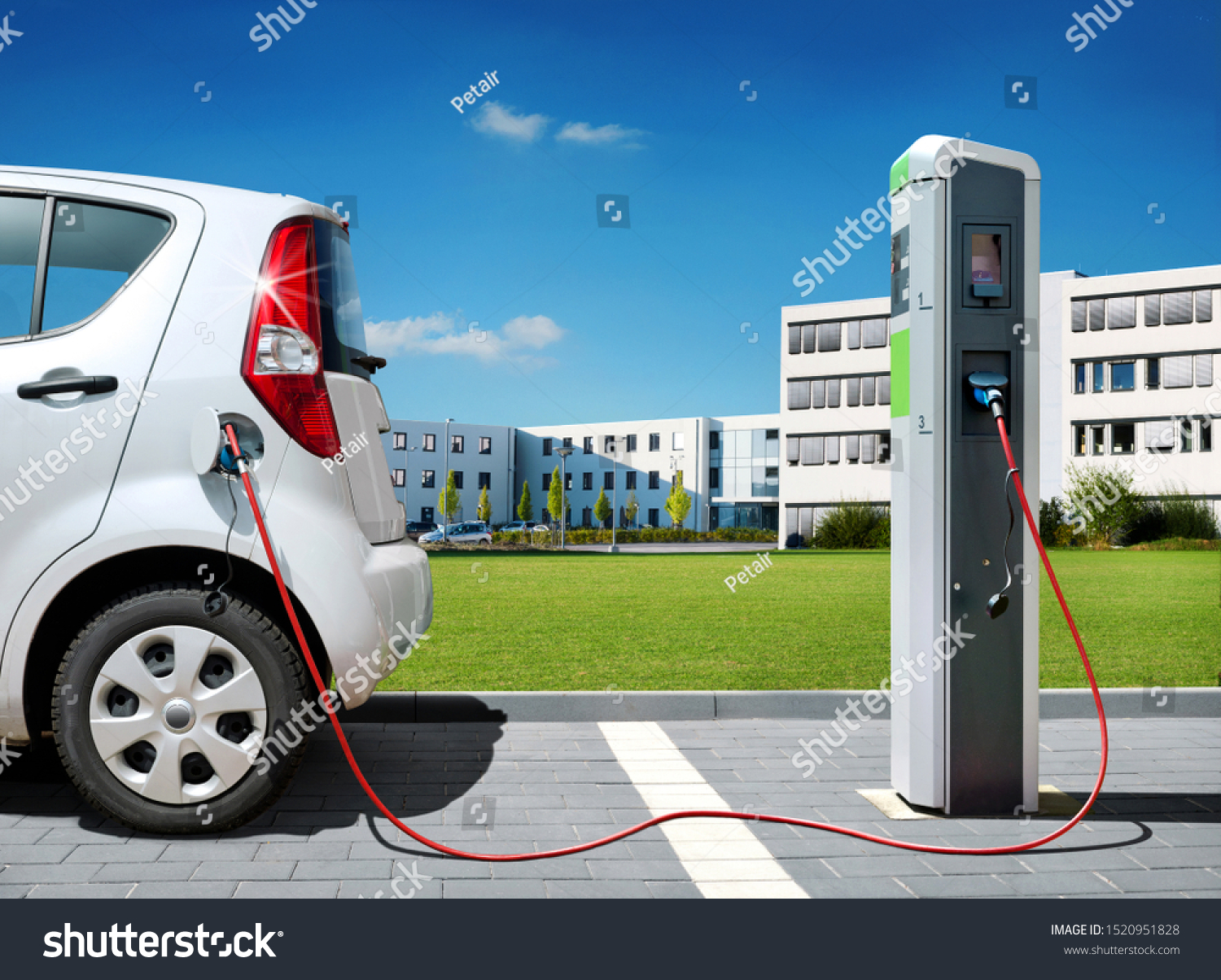 Electric car on charging spot in front of architecture office buildings - Car sharing commuter charging station #1520951828